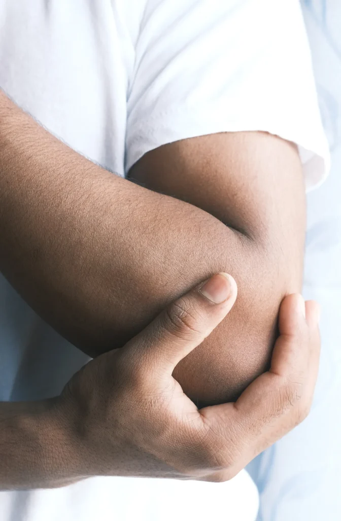 Holding elbow in pain