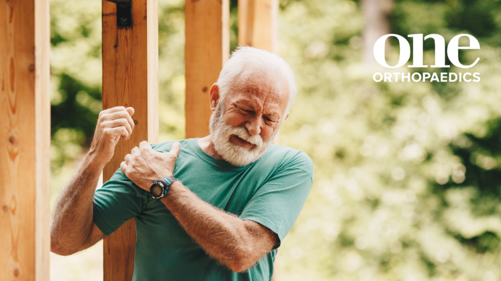 Image of someone with a sore shoulder, holding their shoulder in discomfort