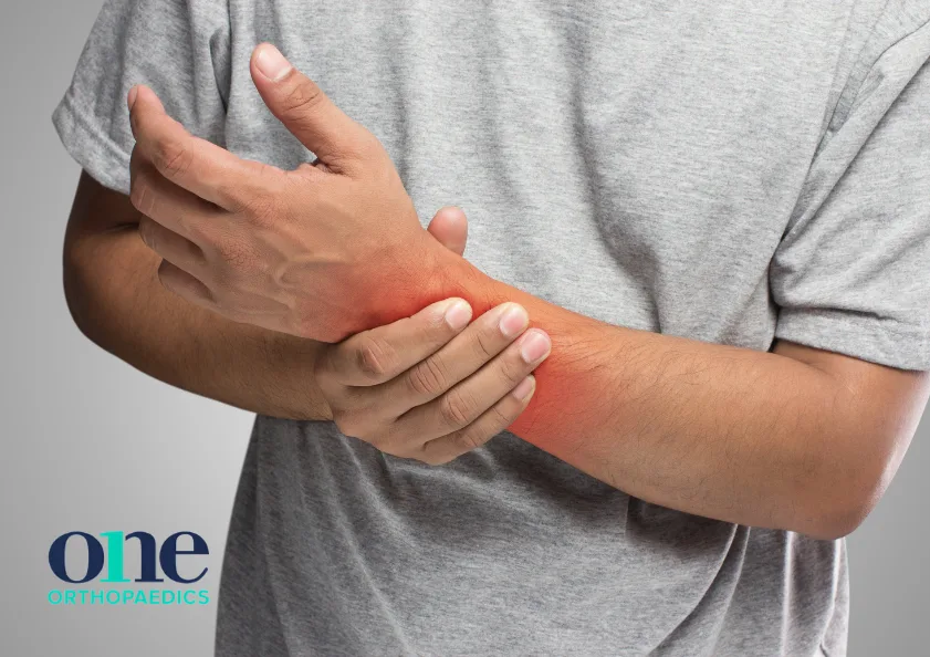 Man holding wrist in pain